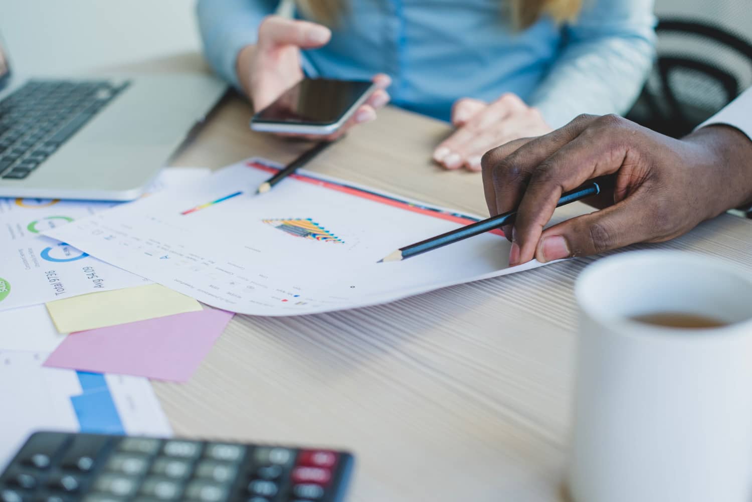 Professional bookkeeper reviewing financial documents with a business owner